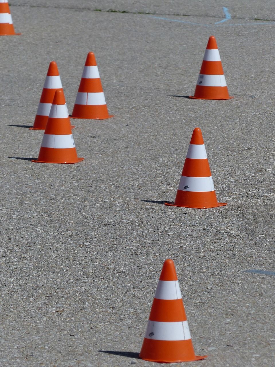 Traffic cones laid out on the ground for a zig zag bike course